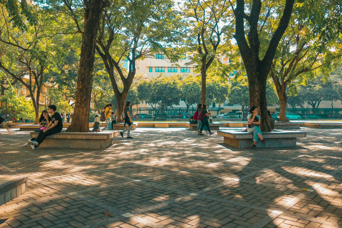 Photo of college students sitting and walking around